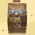 Coffee package with cartoon characters on a beige background, featuring text about 'Nutty Showdown' coffee.