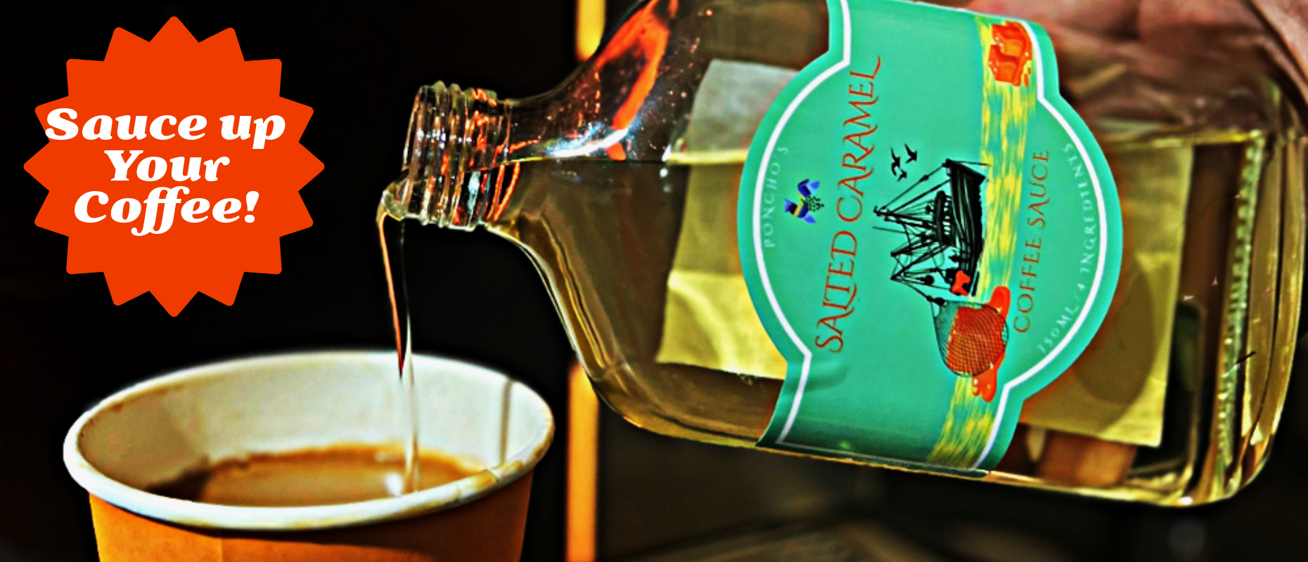 Bottle of salted caramel sauce being poured into a cup of coffee with a label on the bottle.